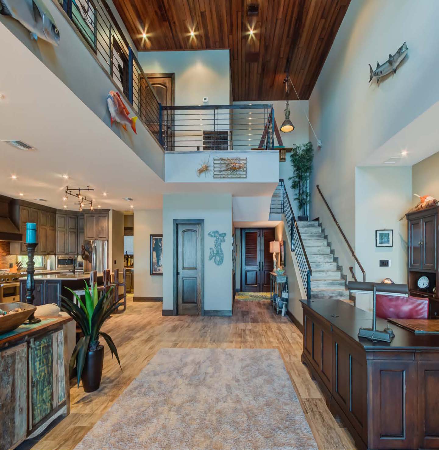 A large open floor plan with a staircase and kitchen.